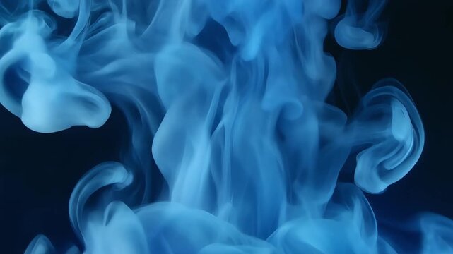 Blue ink clouds swirling and diffusing through dark liquid