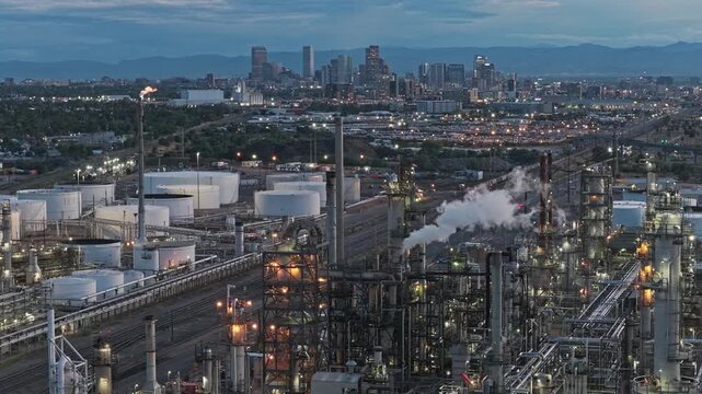 Aerial view of oil refinery at night with city background aerial video Denver Colorado 4K