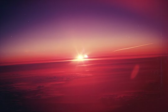 Vibrant sunset over clouds with contrails for website banner or background image