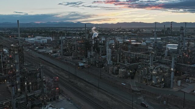 Industrial area plant oil refinery at sunset smoke steam drone video smoke Denver Colorado 4K