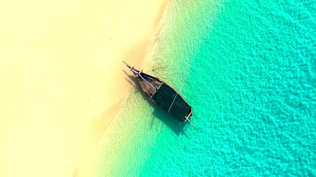 Top-Down Aerial View of Traditional Wooden Boat Anchored on Tropical White Sand Beach