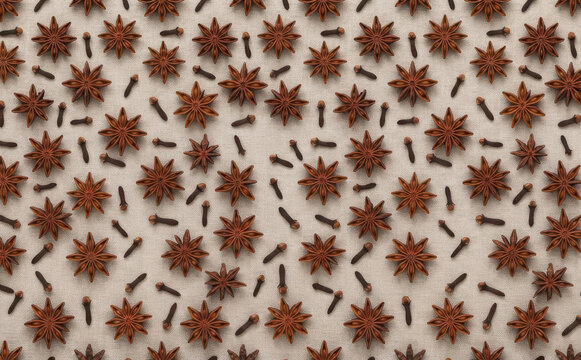 Star anise and cloves flat lay pattern on linen fabric background for culinary spice design, aromatherapy concept and holiday baking photography