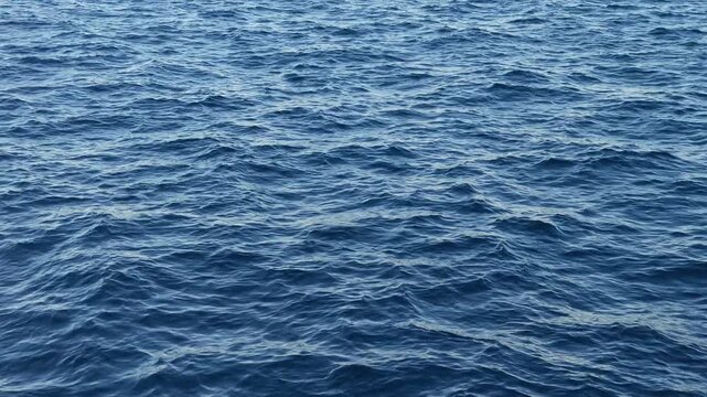 Close up of deep blue ocean water with small waves creating a relaxing and mesmerizing background