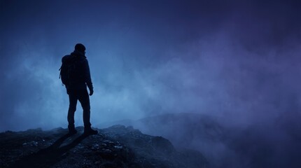 Fototapeta premium Minimalist Hiker Silhouette on Cobalt Blue Misty Mountain for Horror Advertising