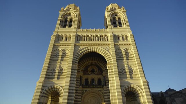 Majestic facade of the Cathedrale La Major in Marseille, France, against a clear blue sky