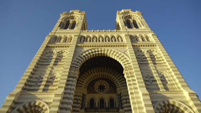 Low angle view of the beautiful facade of the byzantine romanesque cathedral of Marseille, France
