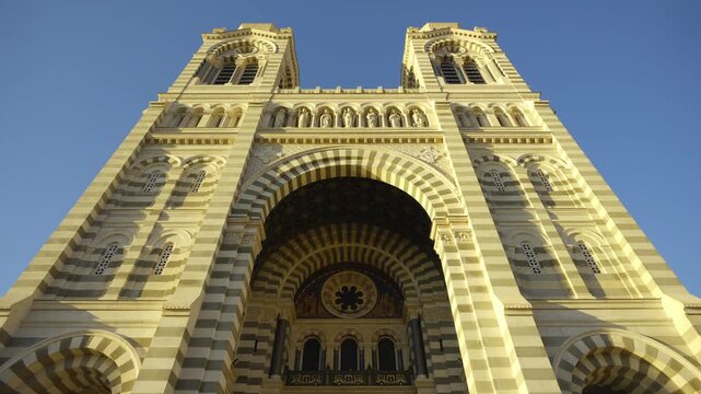 Majestic facade of the Marseille Cathedral with its bell towers against a clear blue sky
