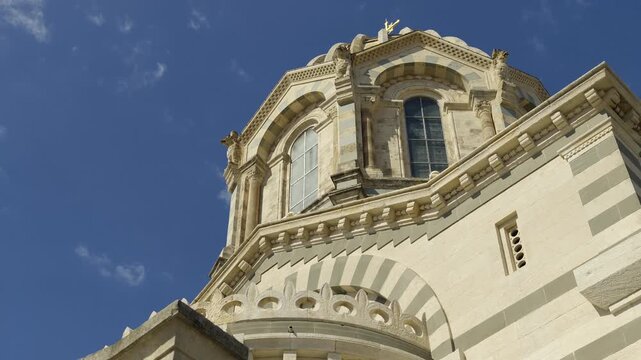 Low angle view of the architectural details of the famous basilica against a bright blue sky