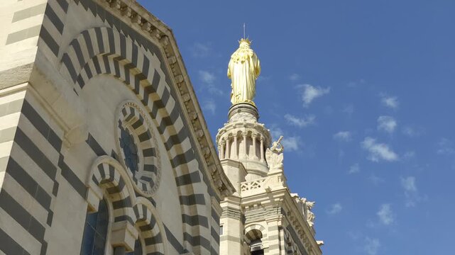 Low angle view of the golden statue of the Virgin Mary atop the bell tower in Marseille, France