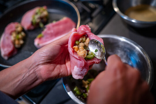 Stuffed pork chop in preparation for cooking on a kitchen counter