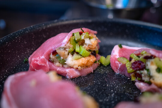Stuffed pork chop in preparation for cooking on a kitchen counter