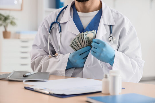 Healthcare corruption and medical bribery, doctor in white coat holding cash money in hospital office for prescription fraud and unethical medical practice
