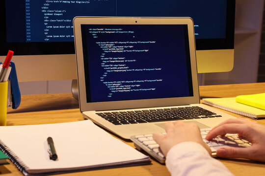 Female programmers hands working in office at night