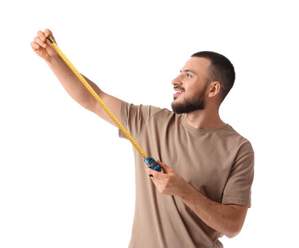 Young man measuring something with tape on white background