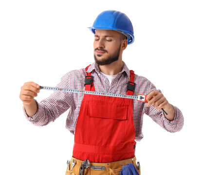 Young male construction worker with measuring tape on white background