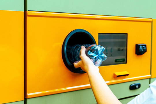 Recycling station collecting bottle through return opening.
