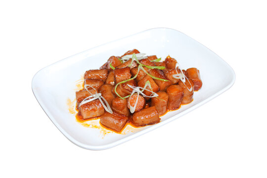 Stir fried sliced sausages in sweet spicy sauce isolated on plain background