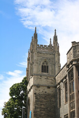 Fototapeta premium Gothic chapel tower rising above green trees