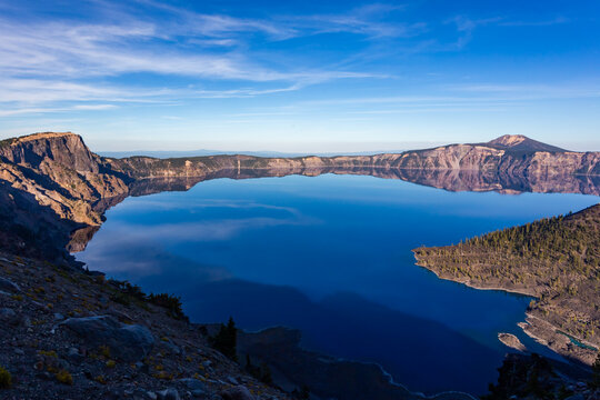 Beautiful blue water of Crater Lake reflecting rim rocks. Crater Lake National Park in Oregon