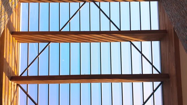 Low Angle View of Glass Skylight Roof with Wooden Support Beams