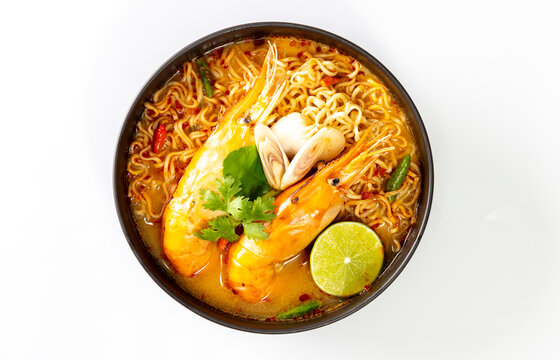 Instant noodles, Tom Yum Goong spicy shrimp soup In a black bowl isolate on white background.