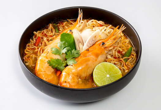 Instant noodles, Tom Yum Goong spicy shrimp soup In a black bowl isolate on white background.
