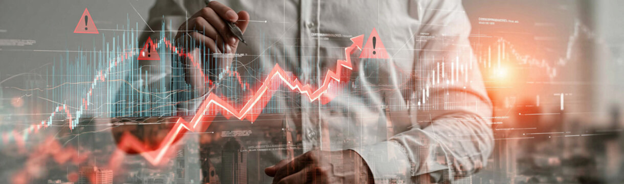 Financial Downturn: A business person in a white shirt observes a red line graph showing a sharp decline, superimposed over a city skyline, symbolizing economic recession.