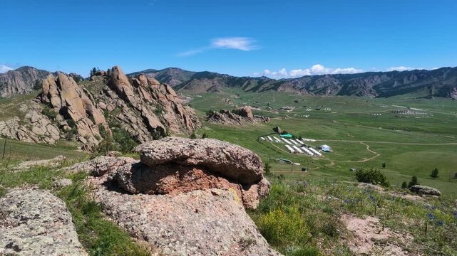 Beautiful green meadow, ger (yurt) and rock mountains landscape in Terelj National Park, Mongolia
