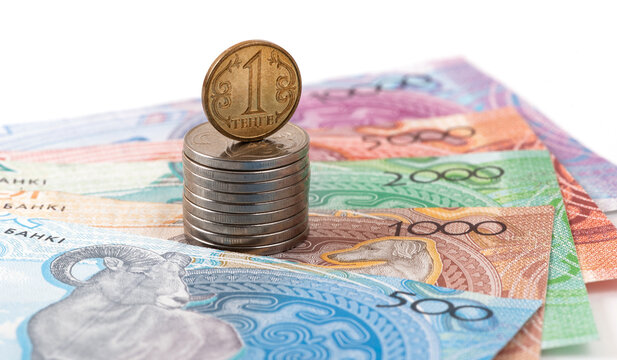 A 1 tenge coin and banknotes in denominations of 500, 1,000, 2,000, 5,000, and 10,000 tenge.
