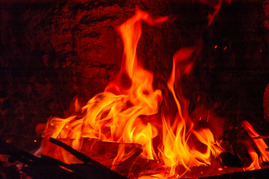 Flames of burning wood inside the fireplace firebox