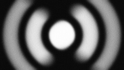 Fototapeta premium Monochromatic concentric rings with a grainy blur texture create a hypnotic radial effect, perfect for abstract motion backgrounds