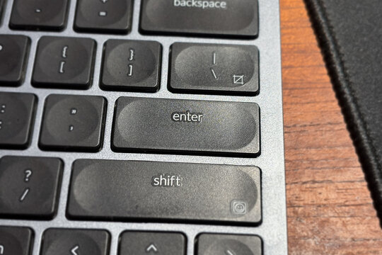 Close up of the enter key on a modern computer keyboard
