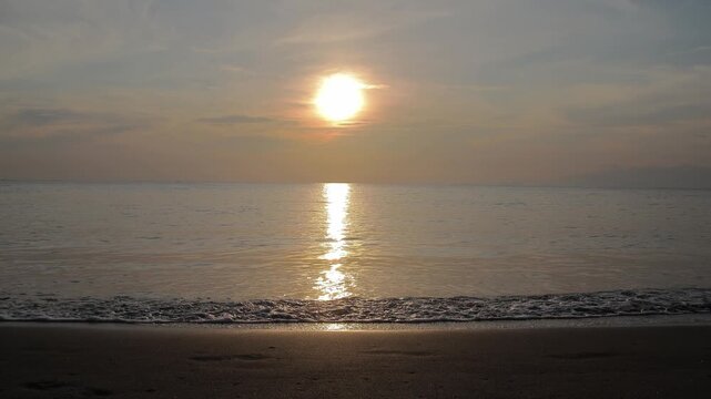 Serene sunset video capturing golden light reflecting on ocean waves creating peaceful atmosphere for travel and relaxation videos, copy space