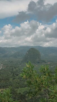 Panoramic view of lush green Tianmen Mountain in Chumphon, Thailand, under a cloudy sky