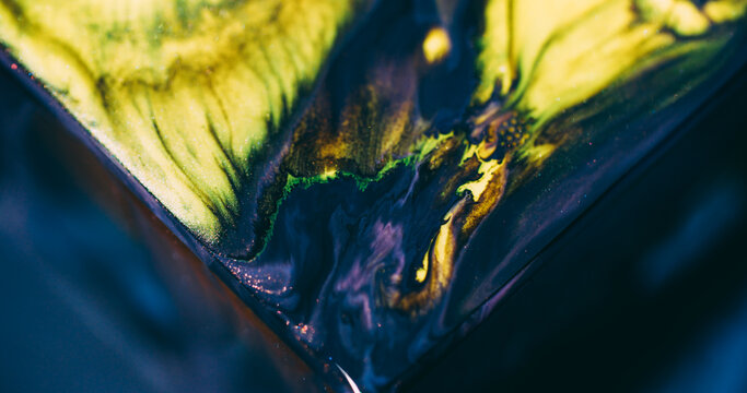Shimmer mix. Color ink. Defocused yellow blue purple triangle sparkling blend texture floating on abstract acrylic background.
