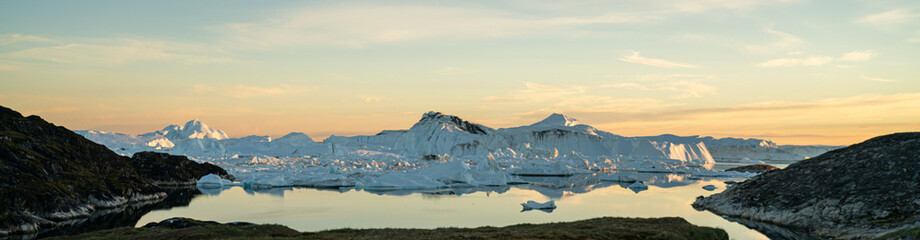 Greenland arctic nature landscape with icebergs in Ilulissat icefjord. Panoramic banner photo of scenery ice and iceberg in Greenland in summer. © Maridav