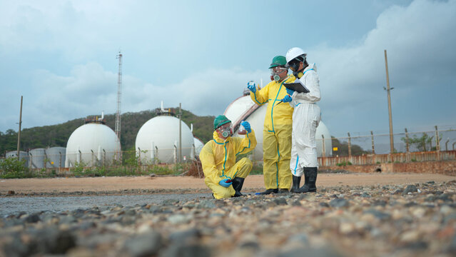 Group of hazmat engineers collecting contaminated water samples