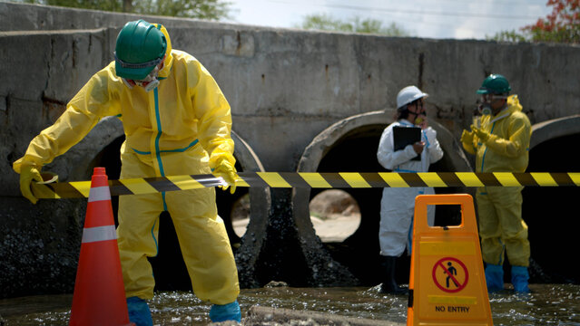 Warning sign and hazardous work area near polluted wastewater drainage tunnel