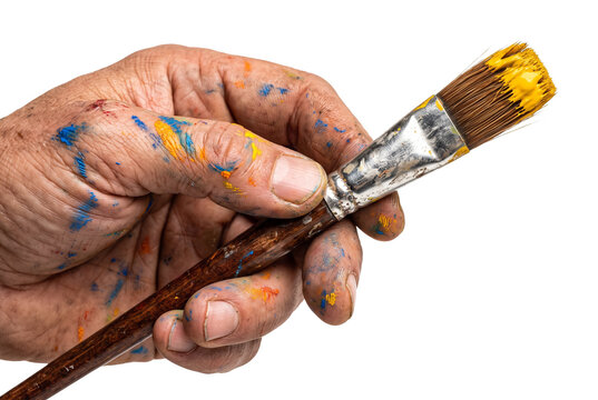 Artist hand holding paintbrush with yellow paint