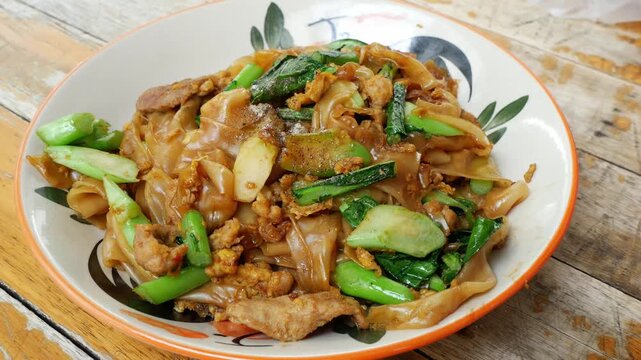 Close-Up of Thai Stir-Fried Wide Rice Noodles with Pork and Kale (Pad See Ew)