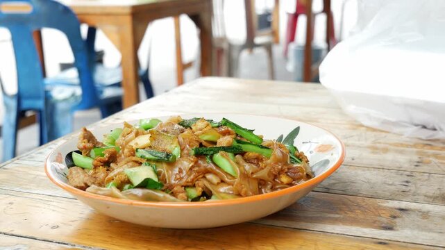 Close-Up of Thai Stir-Fried Wide Rice Noodles with Pork and Kale (Pad See Ew)