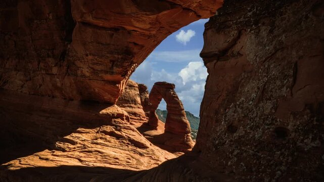 Time lapse video loop of framed Delicate Arch cloud sky. Arches National Park landscape, Utah, USA.