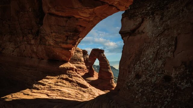 Video loop of framed Delicate Arch cloud sky. Arches National Park landscape, Utah, USA. Time lapse