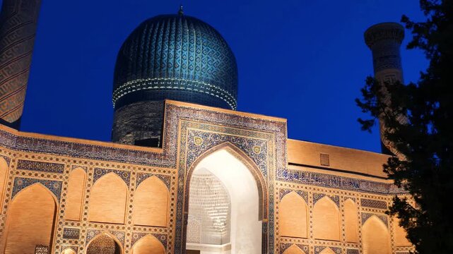 Slow, panning shot of the Timur Mausoleum in Samarkand, Uzbekistan, at night.