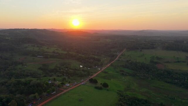 Aerial Flight Over Dirt Road and Agricultural Countryside at Sunset Nueva Alborada Paraguay