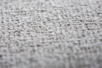 close-up shot of a tightly woven fabric with a mix of light gray and darker threads © pandaclub23