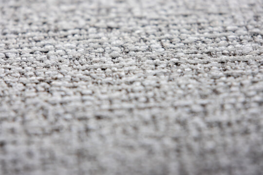 close-up shot of a tightly woven fabric with a mix of light gray and darker threads