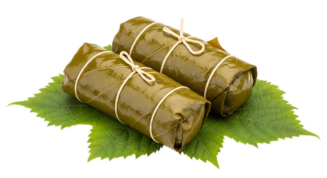 Two wrapped food parcels tied with leaves on a green natural background isolated on transparent background