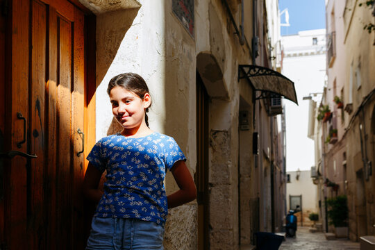 Portrait of Young Girl in Historic Street in Altamura, Apulia, Italy