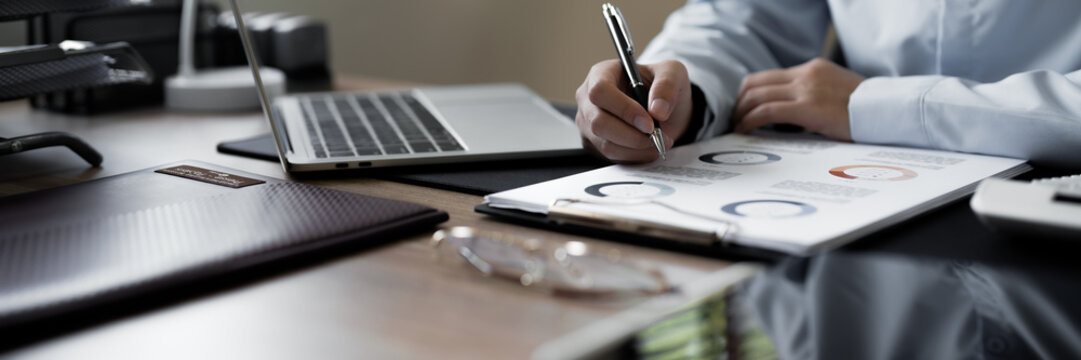 Accountant reviewing numbers in office documents for valuation clarity